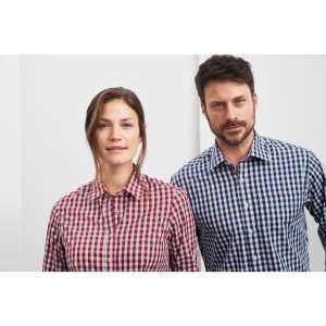 A red and white checked shirt on a woman and a blue and white checked shirt on a man, both featuring button-up designs.