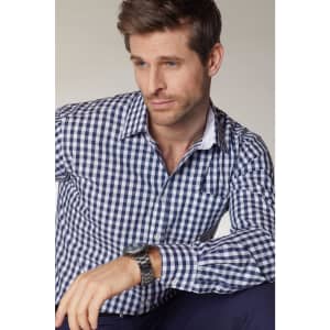 A men's button-up shirt featuring a navy and white check pattern, with a pocket and logo detail.