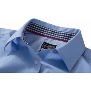 A light blue button-up shirt featuring a checked pattern inside the collar and a branded label.