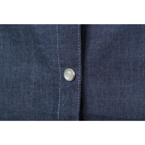A close-up of a ladies denim blouse showing a button and fabric texture in dark blue denim.