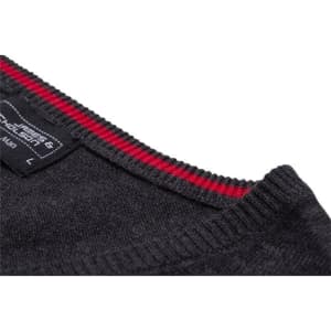 A close-up of a dark grey knitted men's V-neck vest with a red striped neckline and a label visible.