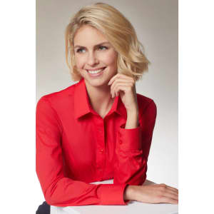 A red button-up shirt with long sleeves, featuring a collar and a fitted style. The model poses with a smile.