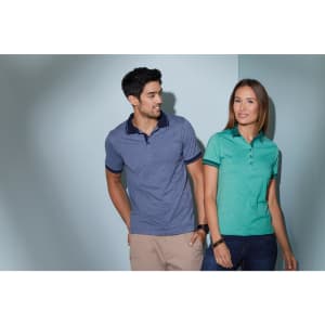 A heather blue polo shirt worn by a man and a mint green polo shirt worn by a woman, both featuring a logo.