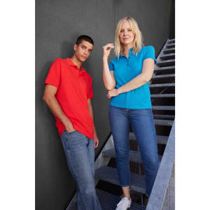 A red polo shirt is worn by a man and a blue polo shirt by a woman, both posing on a metal staircase.