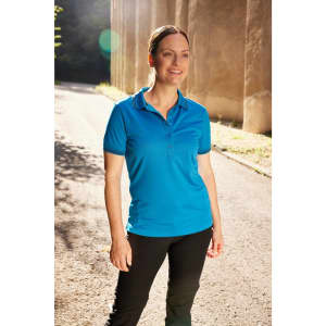 A functional polo shirt in bright blue, featuring a logo, worn by a woman standing outdoors.