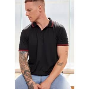 A black polo shirt with red accents, featuring short sleeves and a collar. The model has tattoos and is posing sideways.
