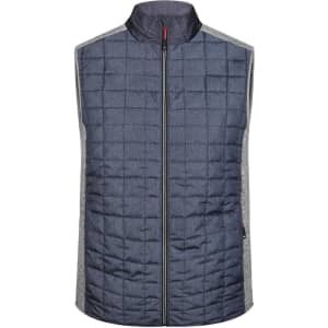 A mens knitted hybrid vest in navy blue with a quilted front and grey side panels. It features a high collar and a zip closure.