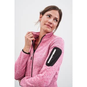 A pink knitted fleece jacket featuring a zip and a black accent on the sleeve, worn by a woman.