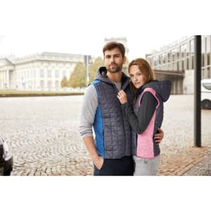 A knitted hybrid vest in blue and pink, featuring a hood, worn by a man and woman in an outdoor setting.