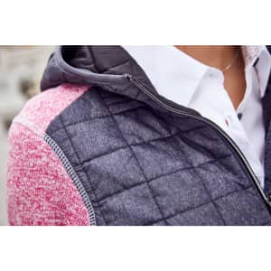 A knitted hybrid jacket featuring a hood, with grey and pink panels, and a quilted texture on the body.