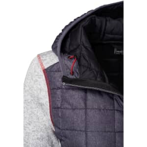A knitted hybrid jacket featuring a grey and navy design with a hood and quilted sections. It has a logo on the inside.