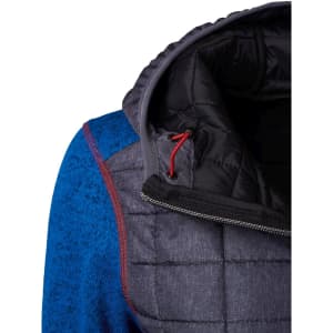 A hybrid jacket featuring a grey body with a blue sleeve, hood, and red stitching, alongside a zippered closure.