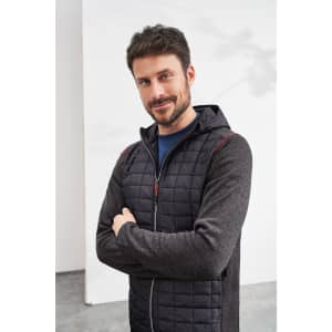 A men's knitted hybrid jacket in grey and black, featuring a zip closure and a hood, displayed on a model.