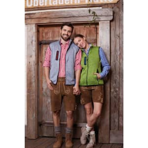 A grey and green ladies knitted fleece vest on a woman, paired with a checked shirt and shorts. Two people stand together.