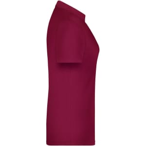 A maroon polo shirt for women, featuring short sleeves and a fitted design. It includes a logo on the front.