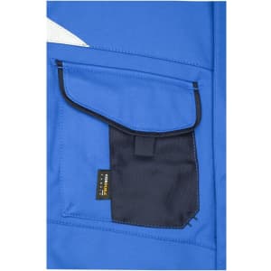 A blue softshell vest featuring a black pocket with a flap and a branding label.