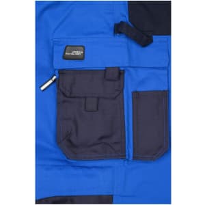 A blue workwear pant featuring a black pocket with a flap and an additional zippered pocket. The garment has a brand logo.