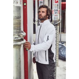 A mens workwear fleece jacket in white and grey, featuring zippers and a branded logo, displayed in a construction environment.