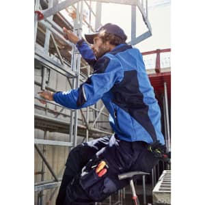 A person in a blue workwear softshell jacket climbs a scaffold with tools visible on their practical pants.