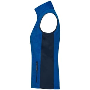 A blue ladies' fleece vest featuring a dark navy side panel and a zippered pocket. Includes a logo on the chest.
