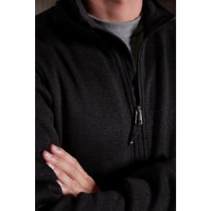 A mens half-zip fleece in black, featuring a zip closure and a textured design. It includes a logo on the garment.