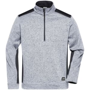 A grey knitted workwear fleece half-zip with black accents and a logo at the bottom. Features long sleeves and a zip collar.