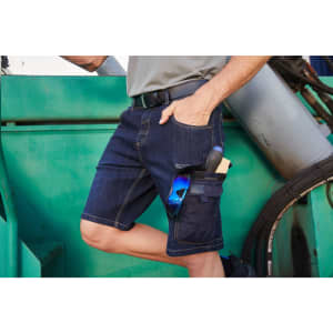 Workwear Stretch Bermuda Jeans in dark blue denim with pockets for tools and sunglasses. Features a belt and relaxed fit.