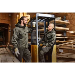 Workwear Softshell Padded Jacket in dark green, featuring a logo, displayed by two people in a construction setting.