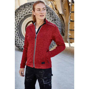 A red polar fleece jacket with a front zip and contrasting details, worn by a model in a work setting.