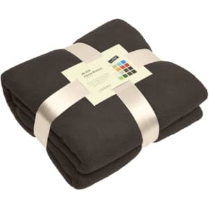 A folded black fleece blanket secured with a ribbon and featuring a tag with colour swatches and a logo.