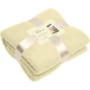 A folded fleece blanket in a light green colour, tied with a ribbon and featuring a label.