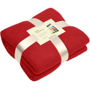 A red fleece blanket neatly folded and tied with a ribbon, featuring a tag with a logo.
