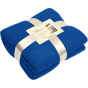 A folded blue fleece blanket secured with a ribbon, accompanied by a product tag and a branding logo.