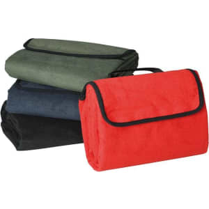 A red picnic blanket with black trim, alongside green, navy, and black folded blankets. Each has a handle for easy carrying.