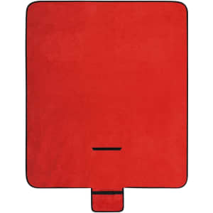 A red picnic blanket with a black border and a compact fold feature for easy storage.