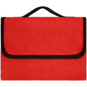 A red picnic blanket with a black trim and a convenient carrying handle. It features a foldable design.