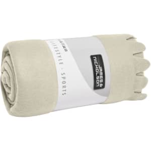 A rolled beige fleece blanket with a branded label, featuring a soft texture and neat edges.