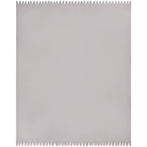 A fleece blanket in a soft grey colour with a jagged edge trim and a logo in one corner.