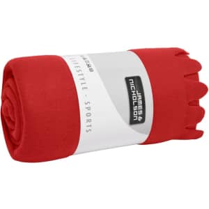 A rolled red fleece blanket with a branded wrapper, featuring a smooth texture.
