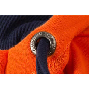 An orange and navy zip-hoodie featuring a metal eyelet for the drawstring.