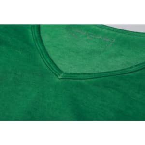 A green ladies' t-shirt features a v-neck design and a smooth fabric texture. It has a logo at the neckline.