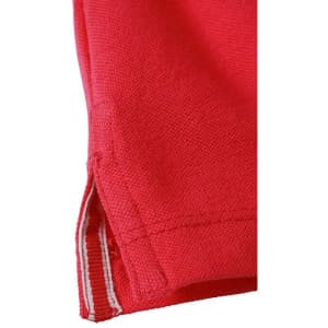 A close-up of a red polo shirt, featuring a textured fabric and a small side vent detail.