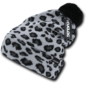 A beanie in black and grey featuring a leopard print design, complete with a pom-pom and a logo tag.