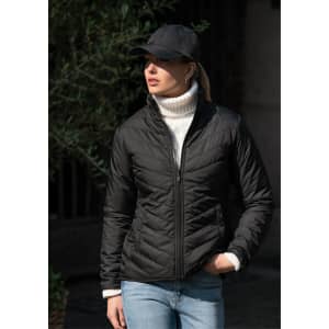 A black women's jacket featured with a high collar, worn with a white turtleneck and a black cap.