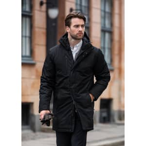 A stylish black puffer jacket with a hood, featuring a front zip and button closure, worn by a man outdoors.