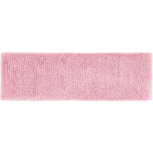 A pink terry headband with a soft, textured surface. It features a logo or branding on it.