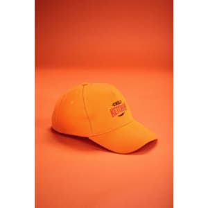 An orange 5 panel cap made from heavy cotton with a logo on the front, set against a similar orange background.