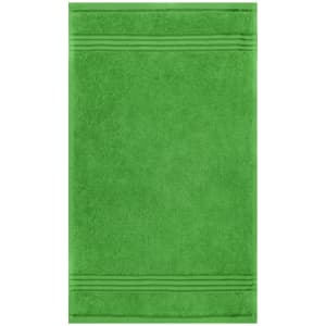 A green guest towel with textured stripes. The towel has a soft, plush appearance and features a logo.