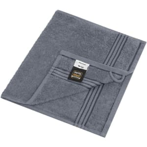 A grey guest towel with a folded corner and a label, featuring subtle striped detailing.