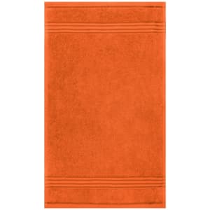 An orange guest towel featuring a textured design with subtle stripes, suitable for health and personal use.